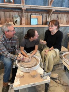 Family learning about the pottery studio