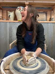 Pottery student on the wheel
