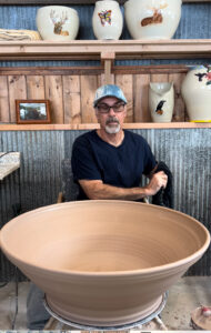 Steve Gordon at pottery wheel teaching students