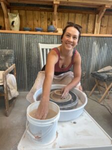 Woman using pottery wheel