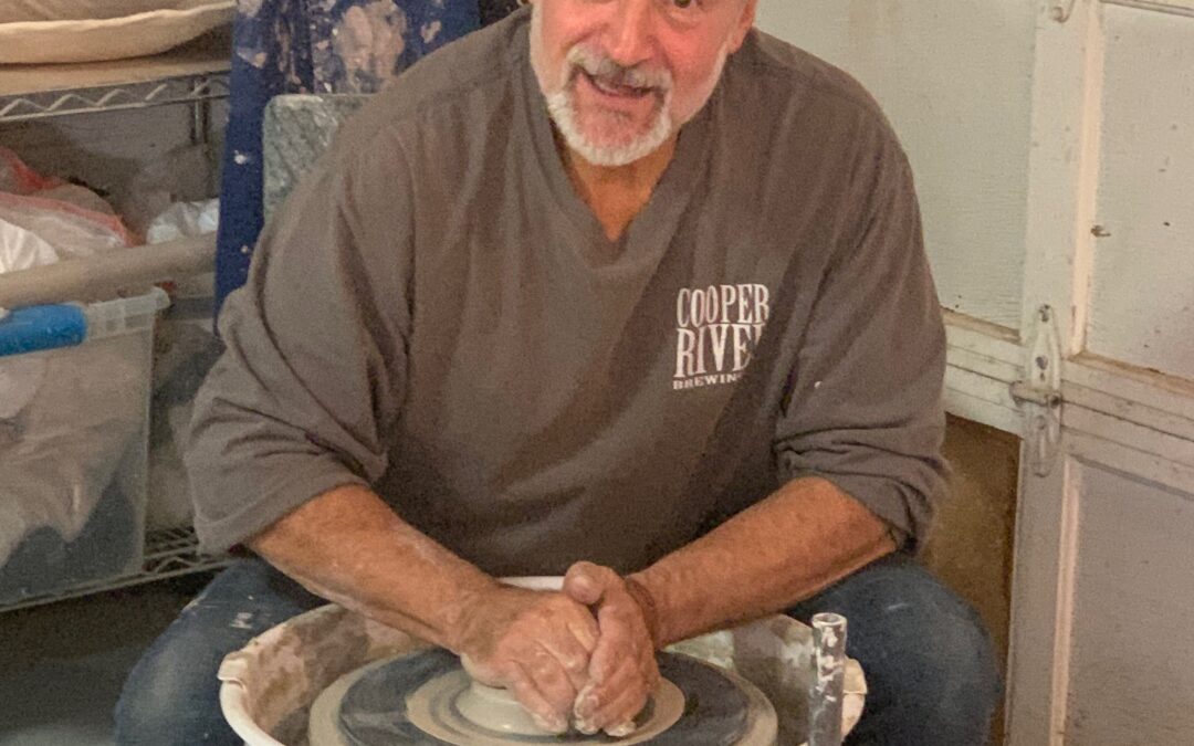 Jim Quick sits at the pottery wheel